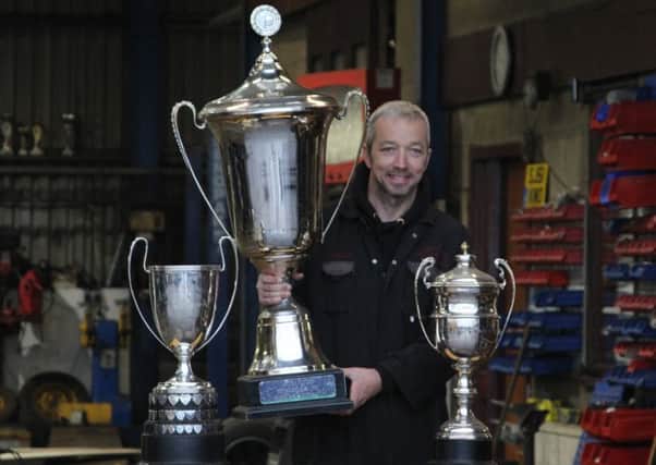 Gordon Moodie with the World, World Cup and Scottish Championship trophies.