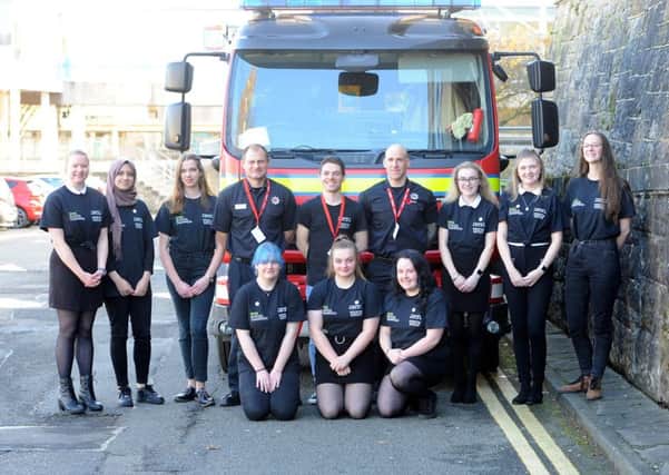Balwearie High pupils at the stem cell recruitment drive with Anthony Nolan representative Danny Angelosanto (centre) and firefighters. Pic: Fife Photo Agency.