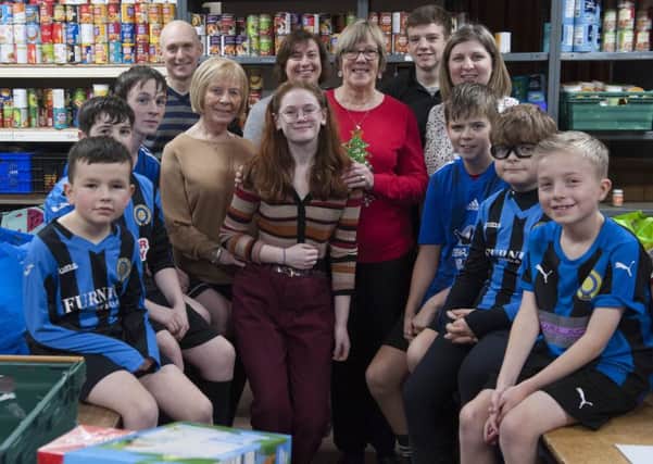 Youngsters from Kirkcaldy Inter football teams gave Kirkcaldy Foodbank a cash boost. Pic: George McLuskie.